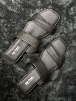 Black Crisscross Slip-On Flats with cushioned footbed and stylish overlapping straps, perfect for everyday wear.