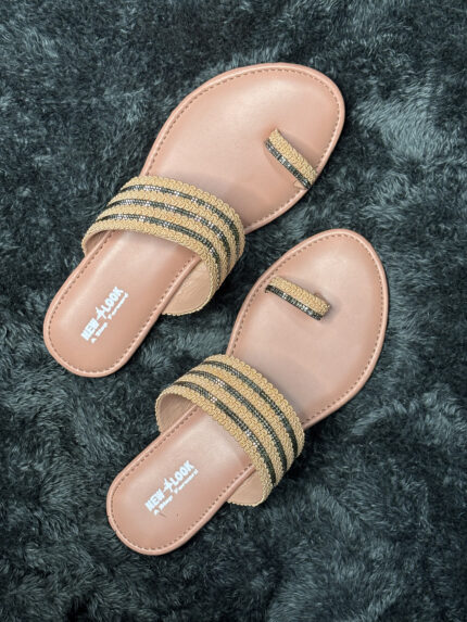 Ethnic gold and black women’s flats with intricate golden detailing, toe-ring strap, and cushioned sole, perfect for festive and traditional wear.