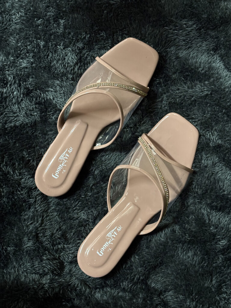 Elegant nude beige party wear sandals with transparent straps and rhinestone embellishments, perfect for weddings and special occasions.