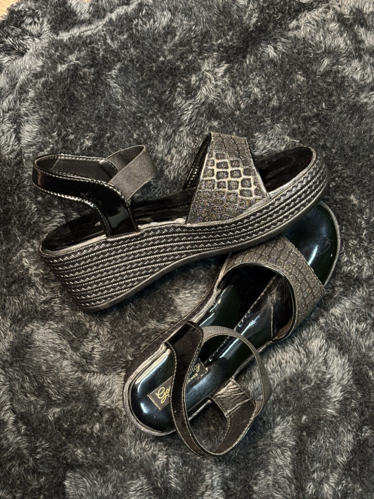 Gold-Touch Women’s Black Platform Sandals with glittery finish, 2.5-inch heel, and elastic ankle strap for secure fit.