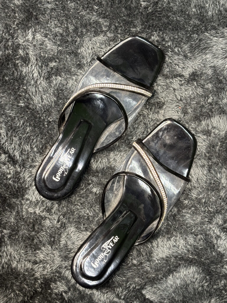 Women’s transparent sandals with rhinestone detailing and clear straps.