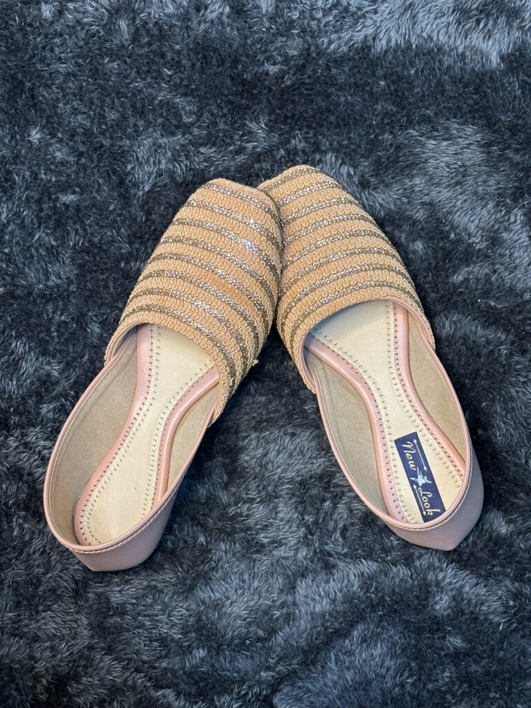 Gold-Striped Flat Slip-On Shoes for Women with peach and gold detailing, featuring a closed-toe design and embroidered patterns.